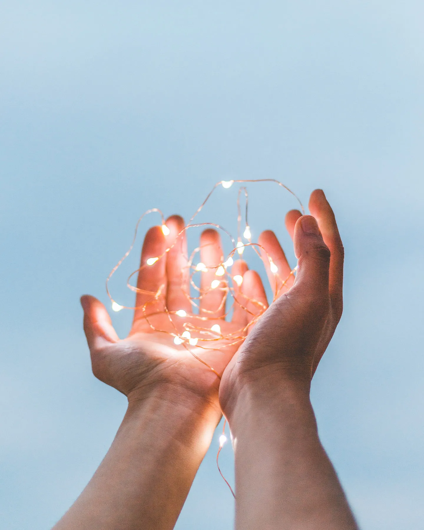 Hands holding fairy light