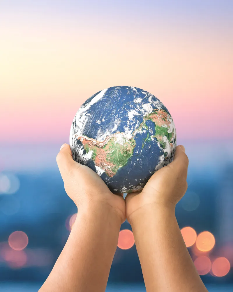 Hands holding a ball that looks like planet earth